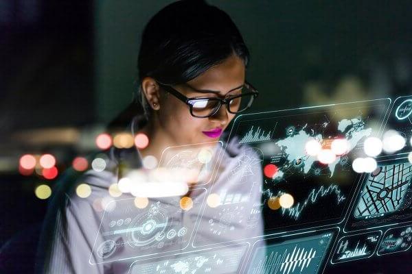 woman engineer looking at various information in screen of futuristic interface